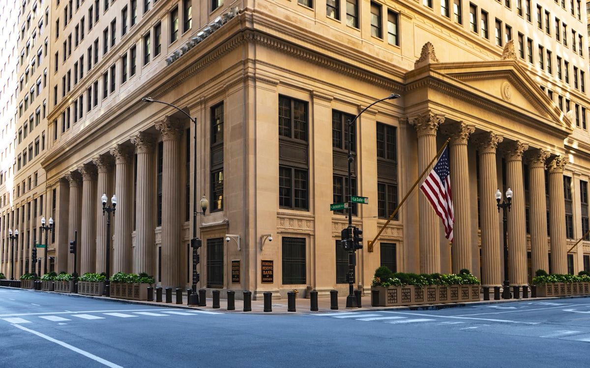 Fed Holds Rates Steady, Signals Two Cuts in 2026